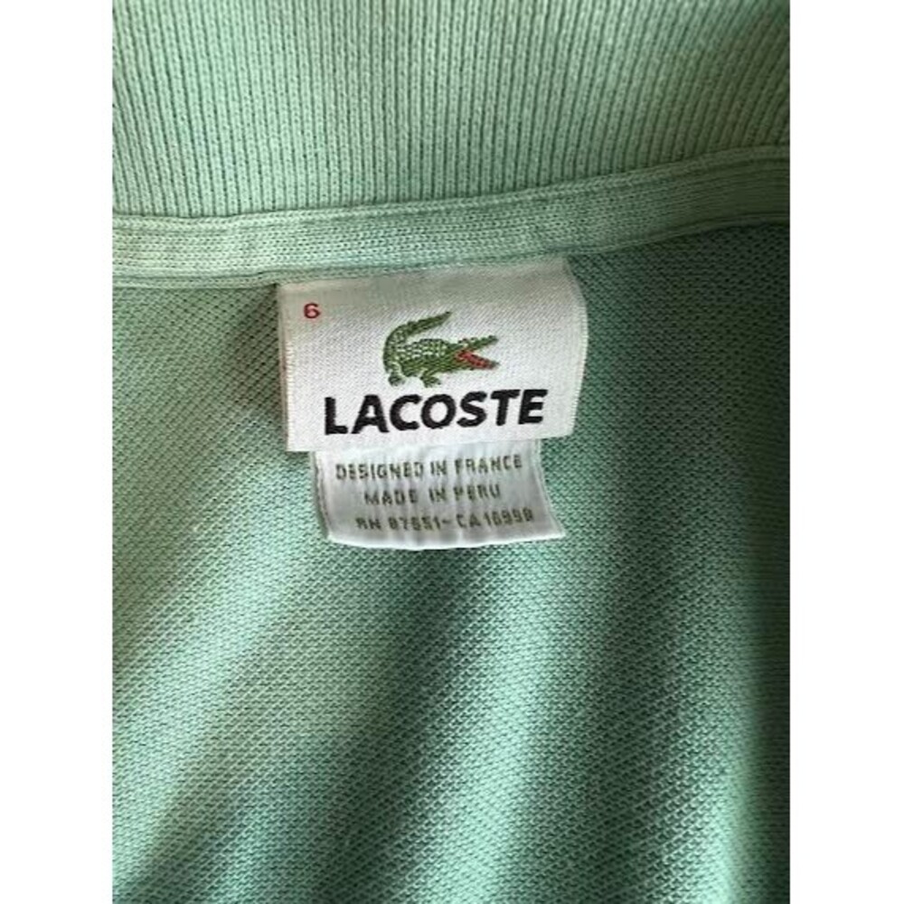 Lacoste Green Sizewith striped on the chest Large or 6 with Small Tear